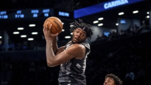 Day'Ron Sharpe grabs a rebound against the Dallas Mavericks on March 24, 2025.|Art or Photo Credit: AP