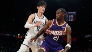 Zeng Fanbo defends against the Phoenix Suns. | Art or Photo Credit: AP